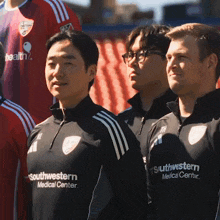 a group of men wearing southwestern medical center shirts stand together