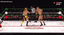 two wrestlers are in a ring with a youtube logo on the bottom