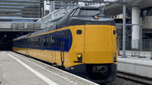 a yellow and blue train with n075 on the front