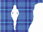 a woman is standing in front of a plaid patterned background