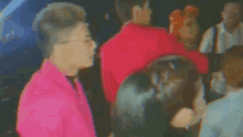 a blurry picture of a group of people dancing in a dark room