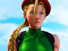 a woman with blonde hair and blue eyes is wearing a red hat and green top