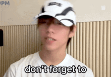 a man wearing a white hat and a white shirt says " don 't forget to "