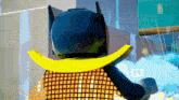 a lego batman is wearing a yellow cape