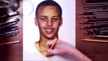 a person is drawing a picture of a basketball player with a marker that says ' prismacolor ' on it