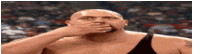 a bald man is covering his mouth with his hand in a wrestling match .