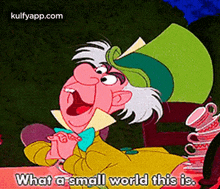 mad hatter from alice in wonderland is sitting at a table with a stack of teacups .