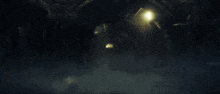 a dark tunnel with a light at the end and smoke coming out of it