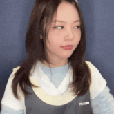 a woman wearing a sweater with the word miu on the back