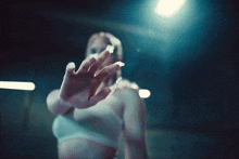 a blurred image of a woman in a white dress