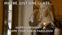 a woman is drinking a glass of wine and wishing a happy birthday .
