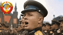 a man in a military uniform is shouting in front of a soviet emblem