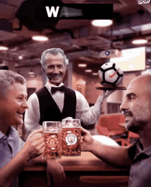 a man in a tuxedo holds a tray with a soccer ball on it in front of two men
