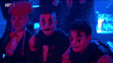 a group of people dressed up in clown costumes with the letters hrt on the bottom