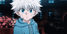 a young boy with white hair and blue eyes is wearing a blue jacket