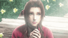 a girl in a red shirt is sitting on a bench with her hands folded in front of flowers .