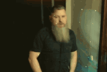 a man with a beard has his arms crossed