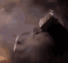 a person is smoking a cigarette in a dark room