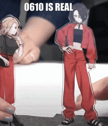 a person is holding a figurine of a girl in red pants