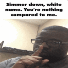 a man with glasses holds his finger to his nose and says simmer down white name