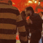 a blurry picture of people standing in front of a stage