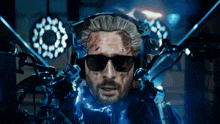 a man wearing sunglasses and headphones is being operated on by a machine