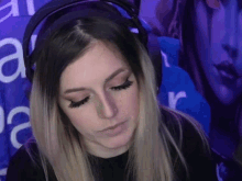 a woman wearing headphones and a nose ring