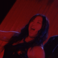 a blurry picture of a woman 's face in a dark room
