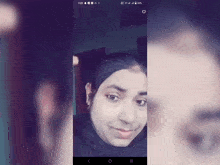 a woman 's face is displayed on a cell phone screen with the time 3:28