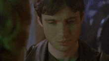 a close up of a man 's face with a grid pattern behind him .