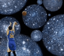 a basketball player with the number 30 on his back throws a ball