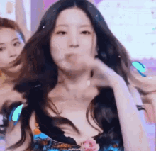 a close up of a woman with long hair making a funny face while dancing .
