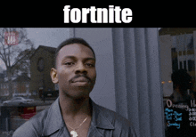 a man standing in front of a building with the word fortnite on the top