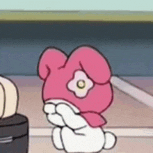 a cartoon of a pink bunny with a flower on its head is covering its face with its hands .