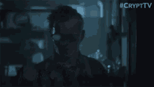 a man in a dark room with #crypttv written on the bottom right