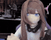 a doll with long brown hair and blue eyes is wearing headphones and holding a video game controller