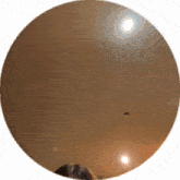 a circle with a reflection of a person in the center