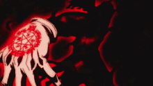 a person 's hand with a red circle on it is surrounded by flames