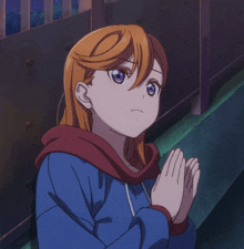 a girl with orange hair and purple eyes is praying with her hands folded