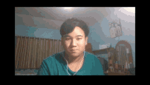 a man wearing earbuds looks at the camera in a room