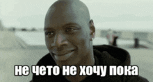 a man in a black hoodie is smiling and says he 's not going to do anything .