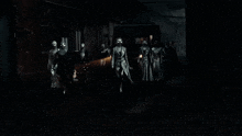a group of people in white masks are walking down a dark alleyway .