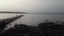 a body of water with a dock in the middle
