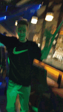 a man wearing a black nike shirt is dancing