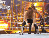 two men are wrestling in a wrestling ring and one of them is carrying another man on his back .