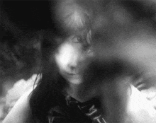 a black and white photo of a young girl with long hair .