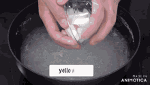 a person is holding a fork over a pot of water that says yello w on it