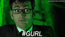 a man wearing glasses and a suit is making a funny face and says # gurl .