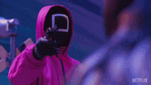 a blurry picture of a person holding a gun with the word netflix on the bottom