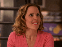 a woman in a pink sweater says that 's great in yellow letters